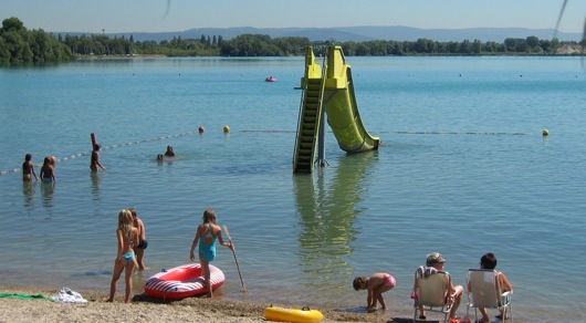 Kids swimming in a lake in Europe.