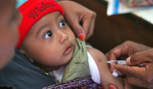 Mother and child being vaccinated at a health clinic.
