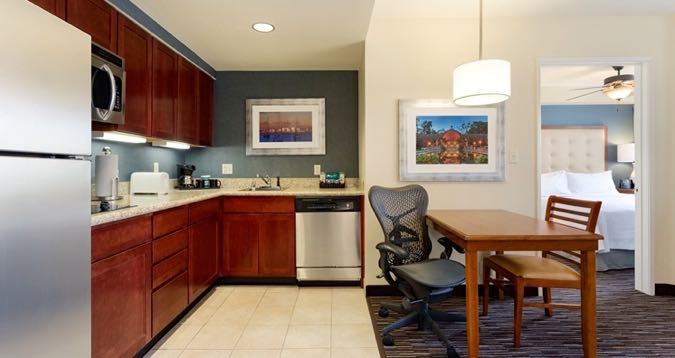 Homewood suites with dining room and kitchen.