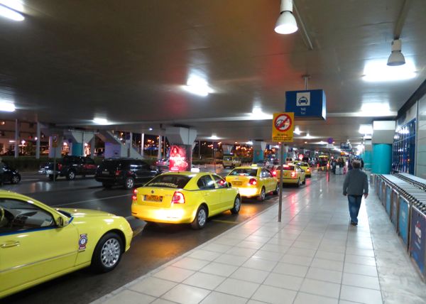 The taxi queue at the Athens airport. Taxis from the Athens airport to Piraeus cost about €50.