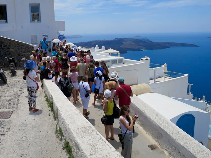 Tour group with view of caldera and volcano.