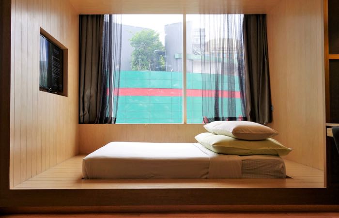 Kuala Lumpur's WOLO Hotel features chic, spare rooms with platform beds. 