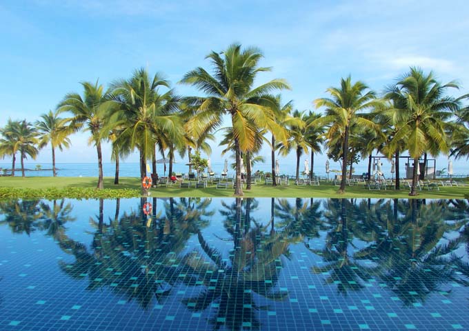 Photogenic pool with views of palm trees and the sea at The Sands Khao Lak