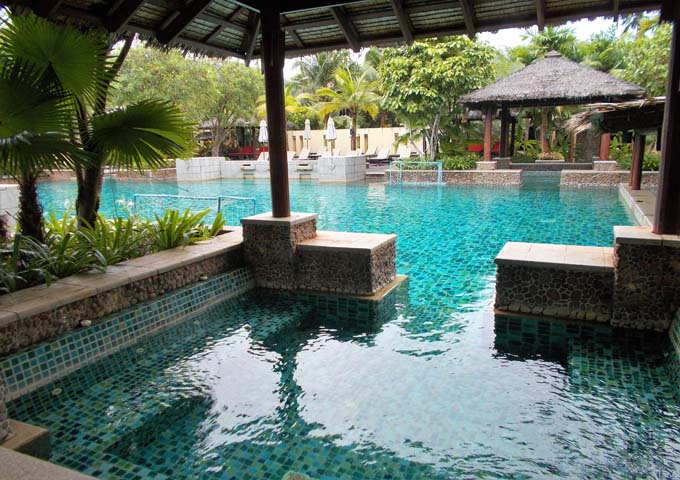 Pool with sitting areas and tropical gardens at kids-friendly Centara Tropicana Resort