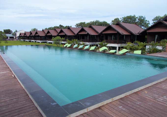 Pool and spacious, wooden villas at the resort