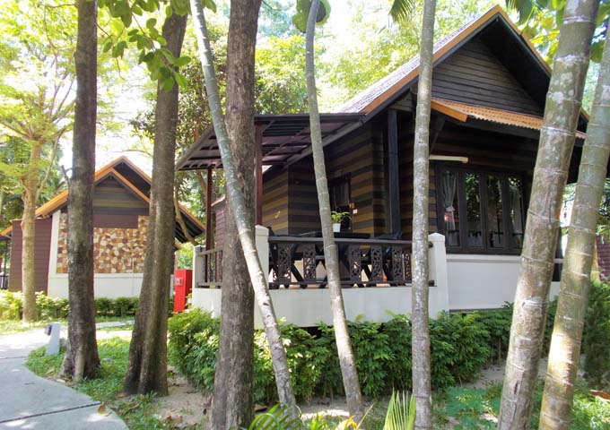 1970s style rustic and charming wooden bungalows around extensive gardens