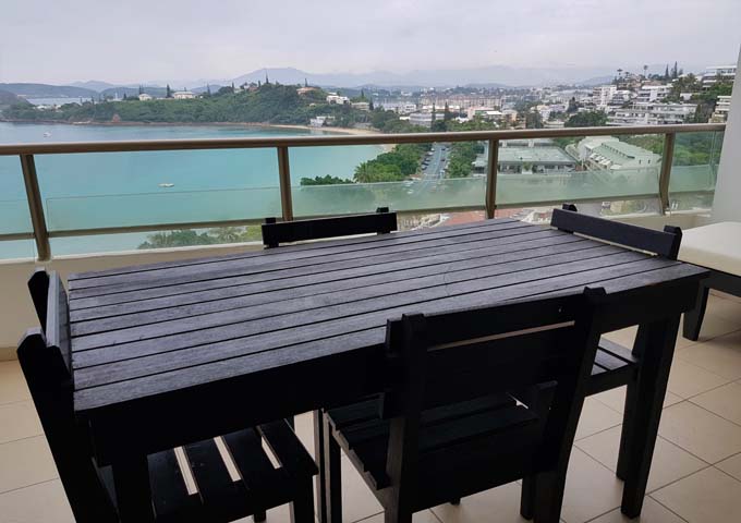 Apartment balconies are furnished for guests to enjoy the views.