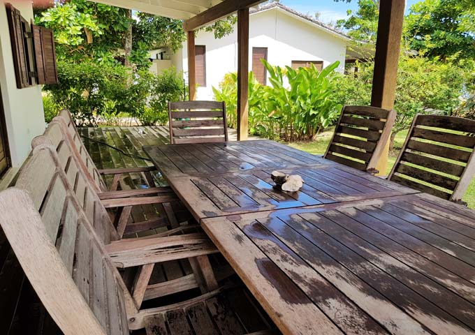 Extended villa patios feature lots of wooden furniture.