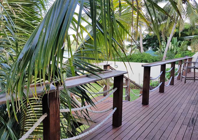 The Main Lodge's wooden deck veranda extends to the sea.