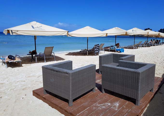 The resort features seating areas and umbrellas on the gorgeous beach.