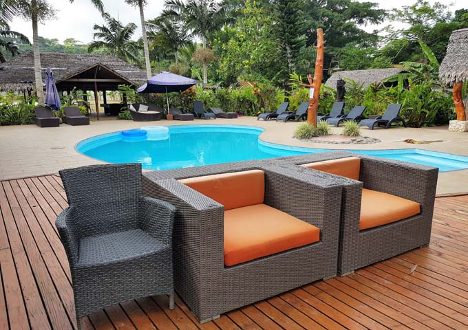 The swimming pool is appealing with its views and wooden deck.