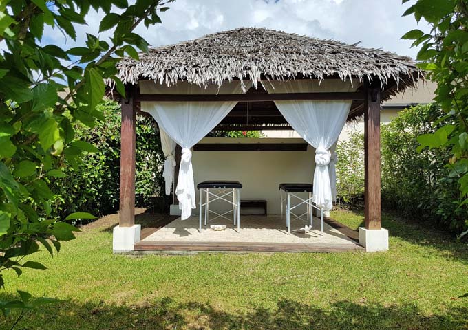 Massages are offered in a thatched hut in the lawn.