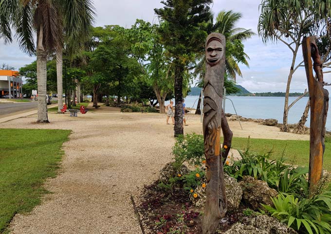 The seaside path to town is decorated with traditional carvings.