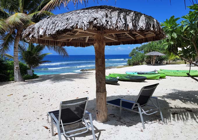 The beach features umbrellas and lounge chairs.