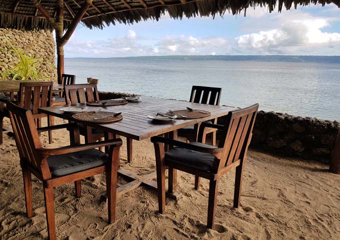 Resort restaurant offers tables by the sea.