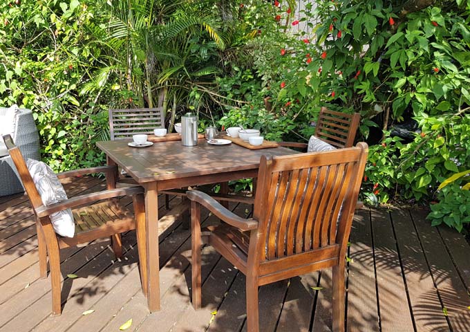 Mangoes restaurant offers wooden seating among tropical plants.