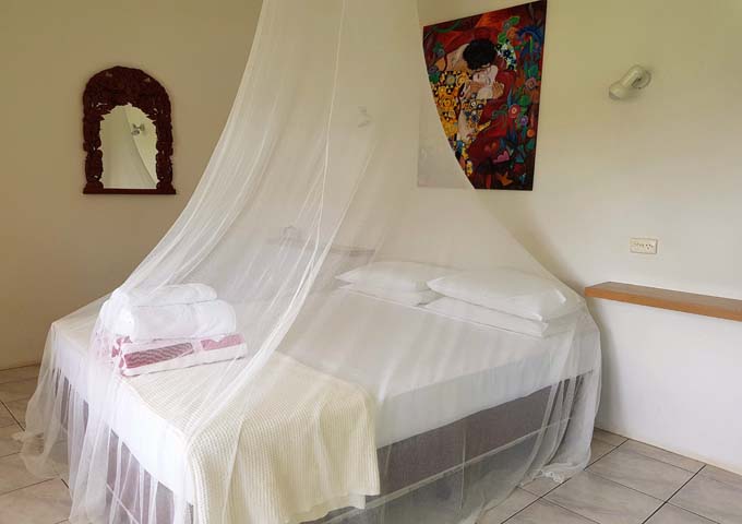 The bedrooms feature an unnecessary mosquito net.