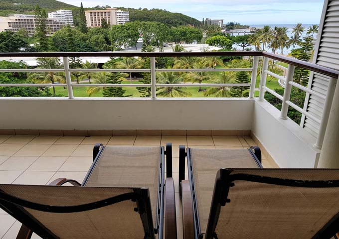 Some room balconies feature lounge chairs.