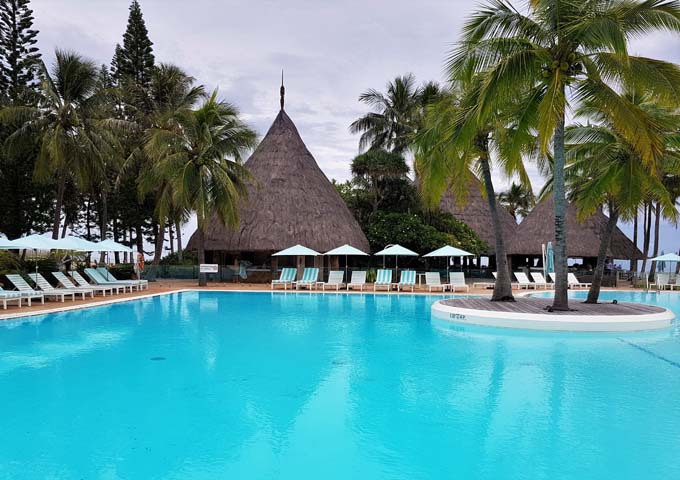 The pool is large and has an island of palms.