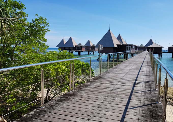 Overwater Bungalows are connected by an extended pier.