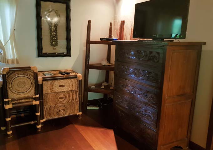 The traditional room furniture is made of dark wood.
