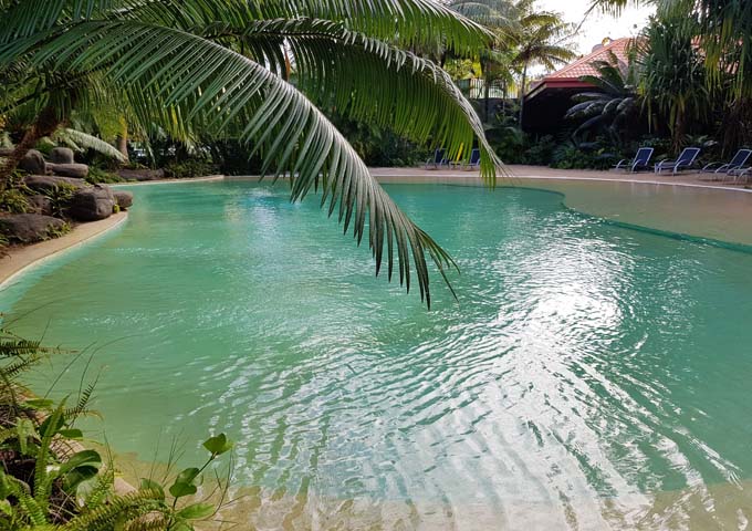 The resort-style pool has palsm and an artifical beach.