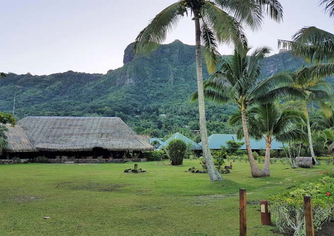 The lodge features tropical palms and lawns.