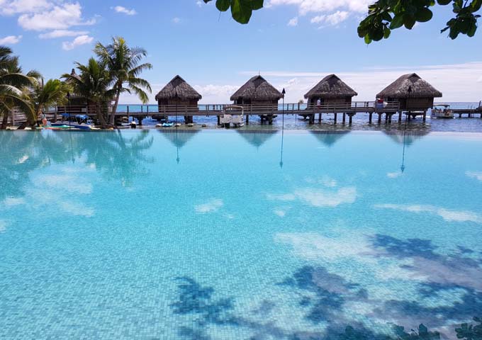 Overwater bungalows and pool at family-friendly Manava Beach Resort & Spa.