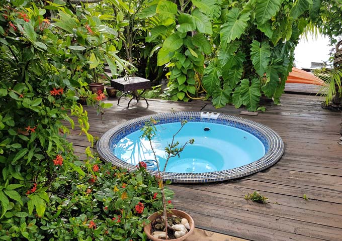 The wooden deck features a small Jacuzzi.