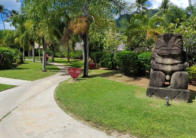 The resort gardens are adorned with traditional stone statues.