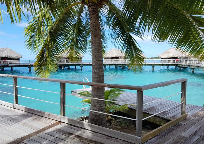 Overwater bungalows at Sofitel Bora Bora Marara Beach Resort are connected by a wooden walkway.
