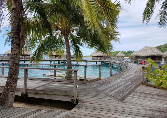 Overwater Bungalows are connected by wooden walkways.