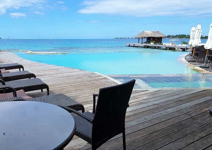 The pool features a wooden deck and fantastic sea views.