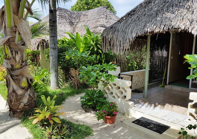 The bungalows feature traditional decor including thatched roofs.