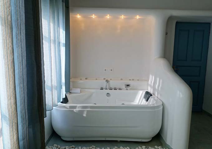 The suite's spacious indoor jacuzzi is by the windows.