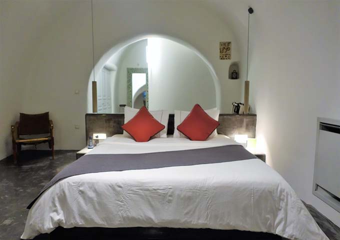 The bedroom has a traditional Cycladic design with modern amenities.