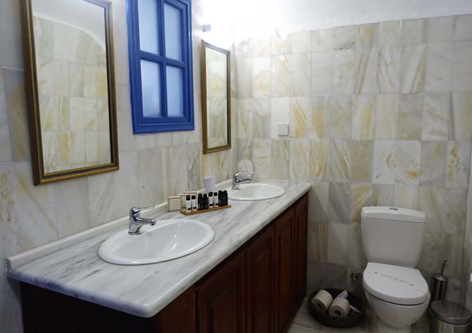 The downstairs bathroom of the Esperas Suite is made of marble and glass.