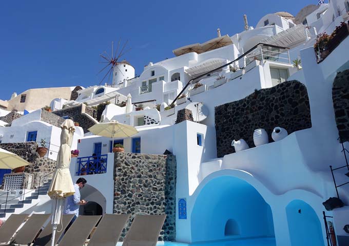 The hotel is located under the Oia windmills, and oversee the caldera below.