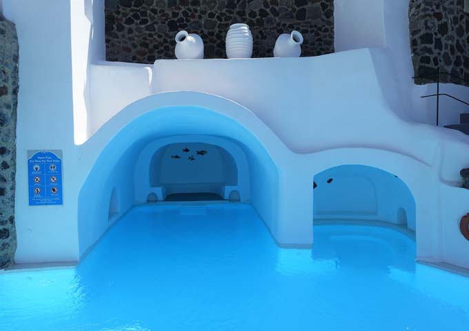 The cave-style pool has 2 shaded and recessed seating areas.