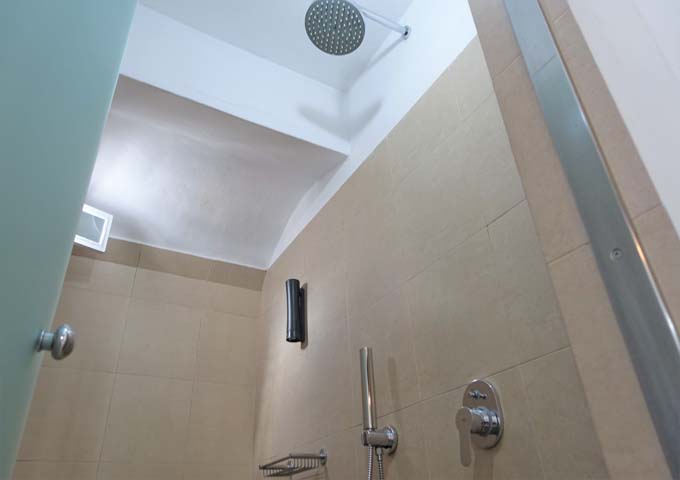 The bathroom also has a large modern shower.