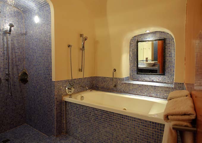 The second bathroom has an open shower and jacuzzi.