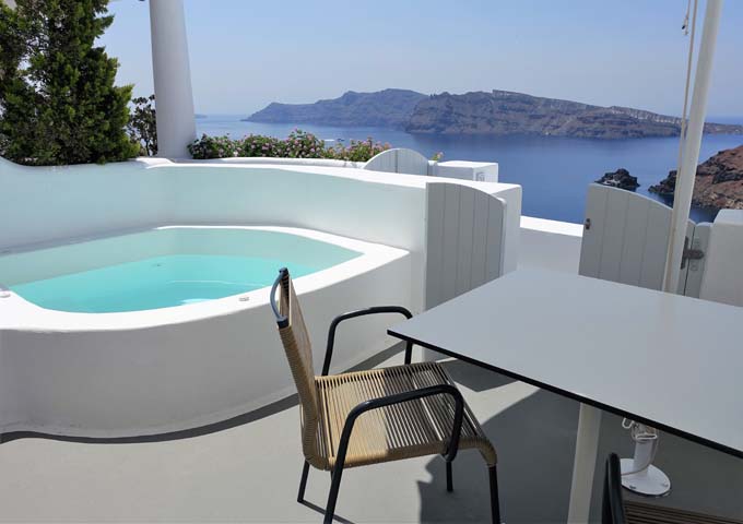 The private terrace is well-furnished with a jacuzzi and a dining area.