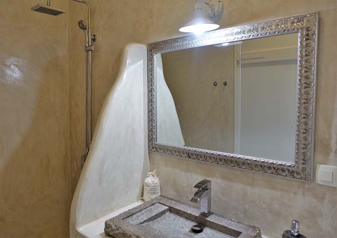 The villa bathrooms have cave-style showers and rock sinks.