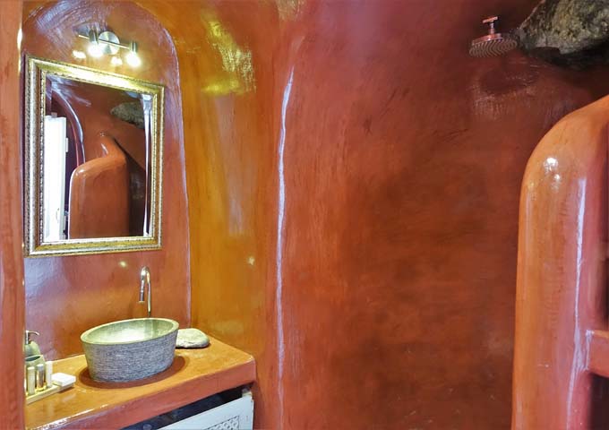 The upstairs bathroom is cave-style and brightly-colored.