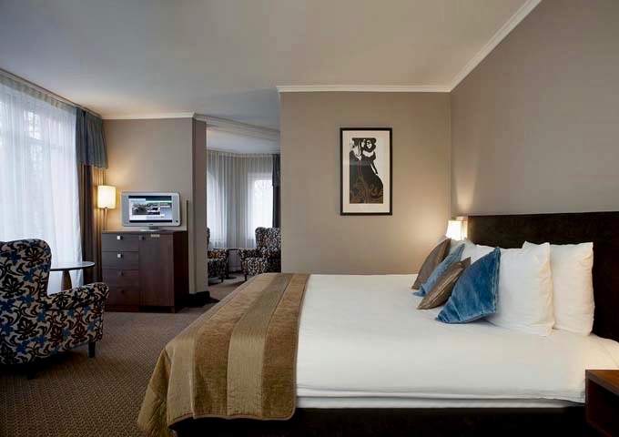 Junior Suites feature comfortable living areas with flat-screen TVs.