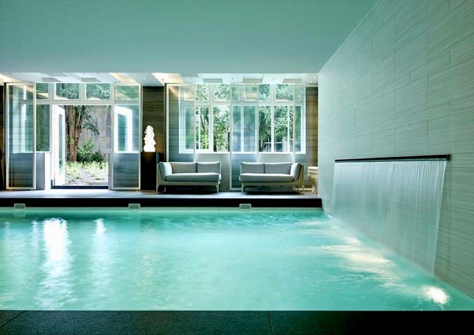 The indoor pool has a waterfall feature.