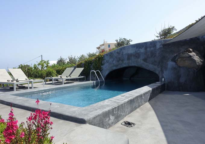 The villa features a semi-shaded cave pool.