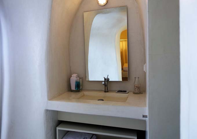 The modern bathroom also features traditional architecture like a pressed concrete vanity area.