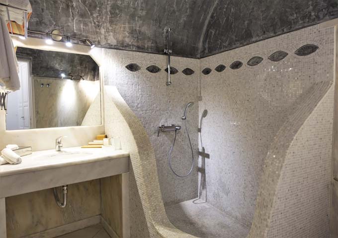 The spacious bathroom has a shower for 2 and a marble sink.