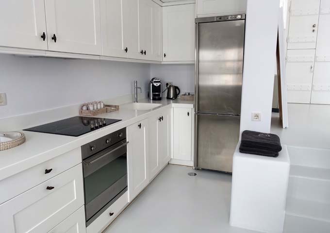 The kitchen is well-equipped, and includes a full refrigerator.